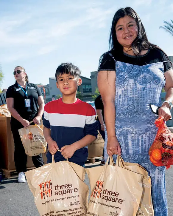Three_Square_Giving_2 3_opt Family picking up food from Three Square food pantry